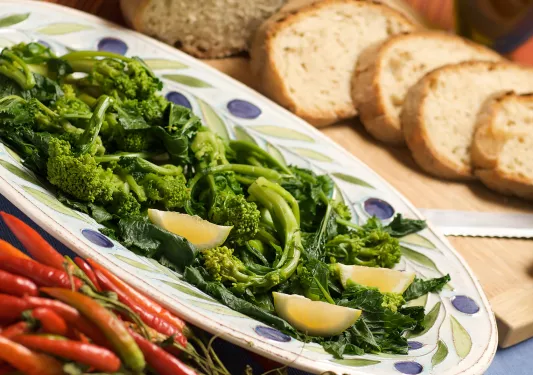 Platter of broccolini, chilis and bread.