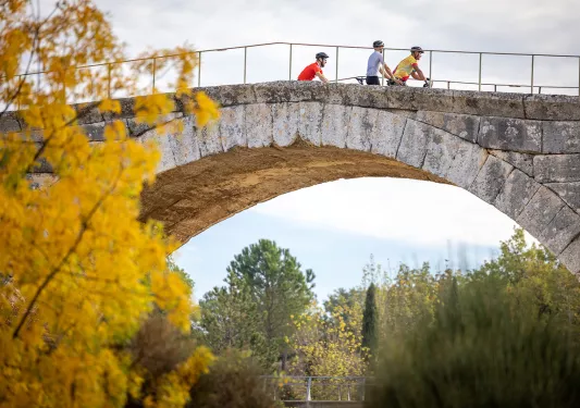 Backroads Guests Biking Over Bridge