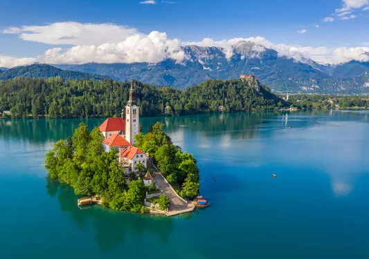 Church on island in center of blue lake.