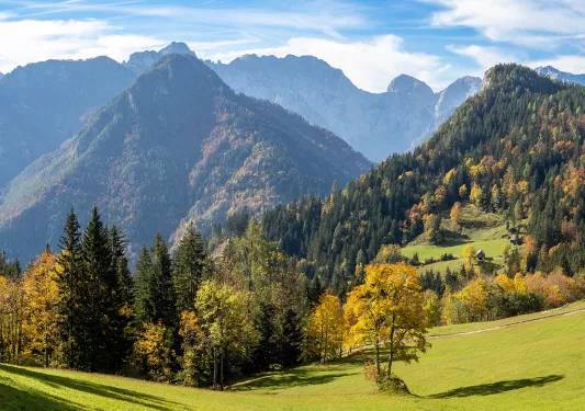 Valley view of Alpine mountains and clouds at the base.