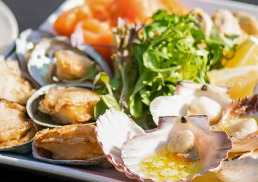 Cooked seafood platter with salad.