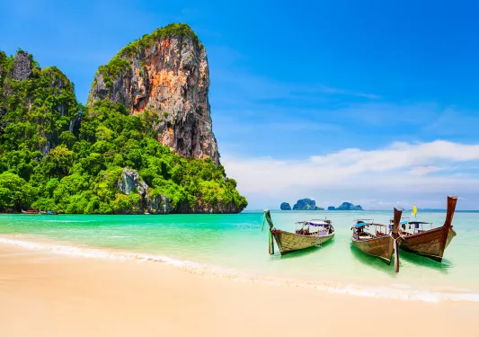 Boats resting on a sandy beach in Thailand