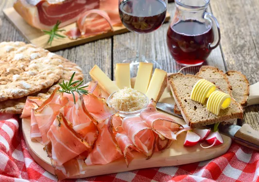 Shot of cured meats, cheese, bread, butter, wine, etc.