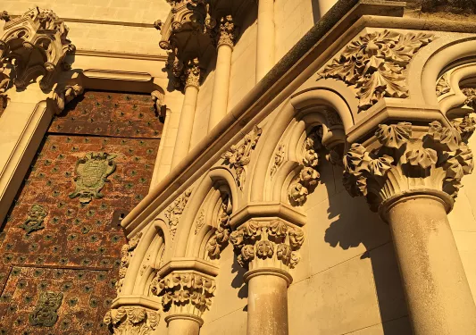 Close-up shot of decorative cathedral, spiked metal door.