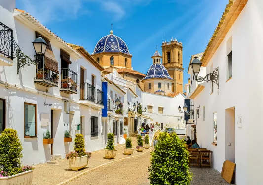 Wide shot of Altea Old Town alleyway.