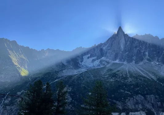 Shot of large mountain eclipsing sun, camera is in shadow.