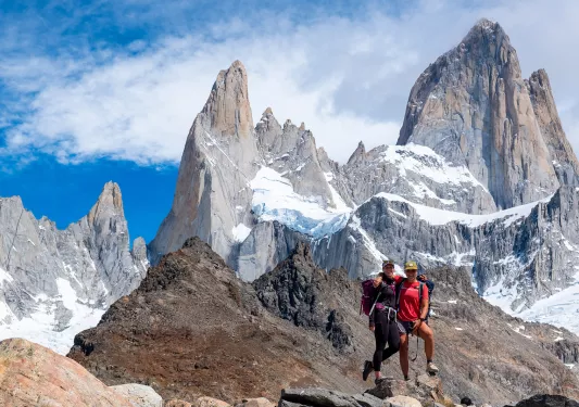 Two hikers posing on top of a rock in Patagonia.