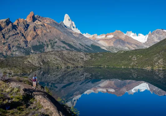 Guest overlooking large lake, ring of mountains in distance. 