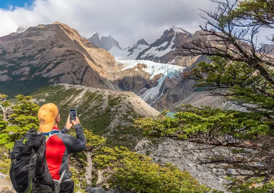 Guest taking photo of snowy mountain.