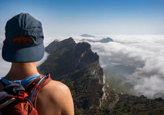 Backroads Guest Overlooking Rock Formation in Clouds