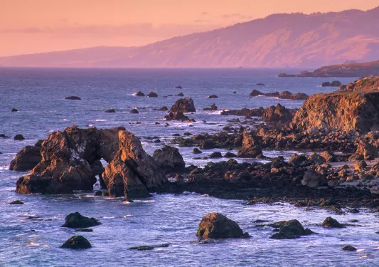 Sunset shot of rocky California coastline.