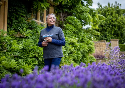Backroads guest in English flower garden with blooming lavender. 