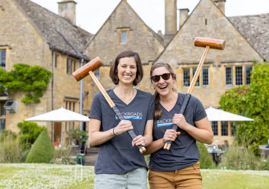Two Backroads guests playing croquet in England.