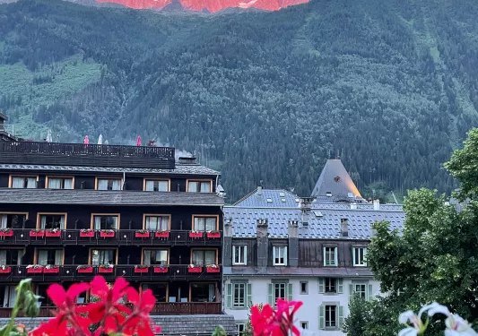 Point of view shot of Chamonix Mont Blanc, sunset illuminating mountaintops.