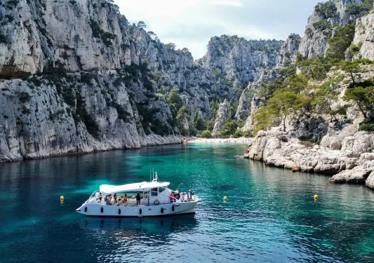 Boat on Water Surrounded by Rocks