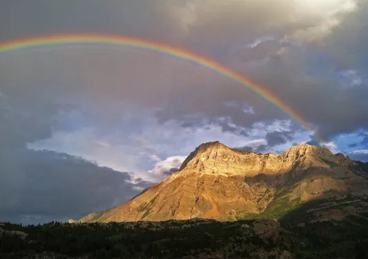 Rainbow stretching over mountain landscape