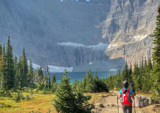 Backroads guest hiking towards lake at the bottom of mountain 