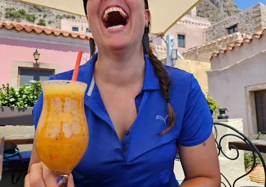 Backroads guest enjoying tropical drink in Greece.