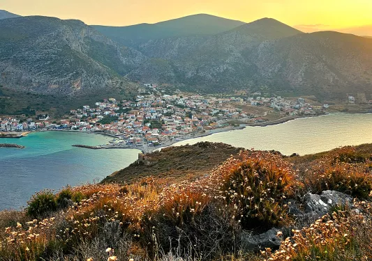 Wide shot of coastal Mediterranean town during sunset.