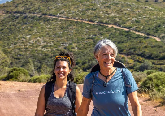 Two hikers on a trail in Greece.