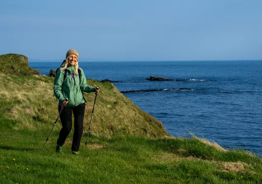 Hiker posing on a rock, clifside.
