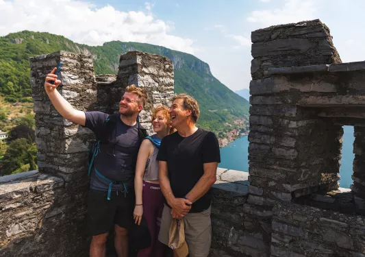 Three guests taking selfie on castle roof.