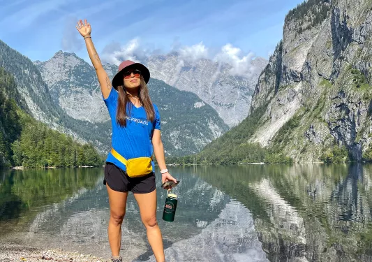 Hiker posing in front of lake in Bavaria.