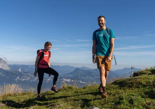 Two hikers on top of a hill. 