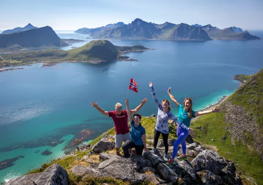 Aerial Guests with Norwegian Flag Above Fjord Norway