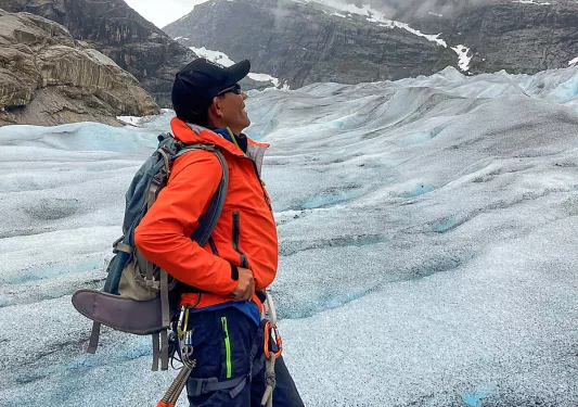 Solo hiker gazing out on a glacier