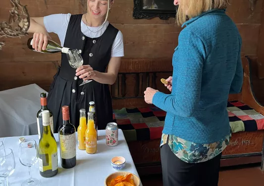 Women enjoying a picnic and pouring local wines.