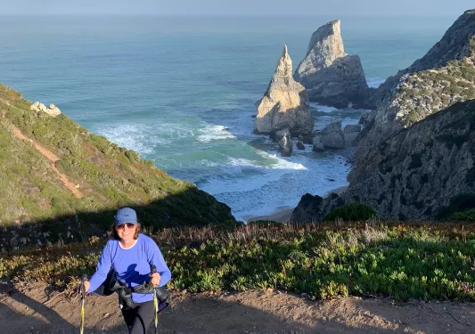 A woman walking along the coast