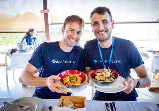 Two leaders with bowls of seafood.