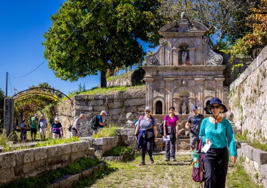 Guests walking among hilly stone ruins.