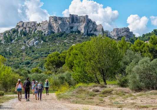 Backroads Guests Walking Towards Rock Formation in Mountain
