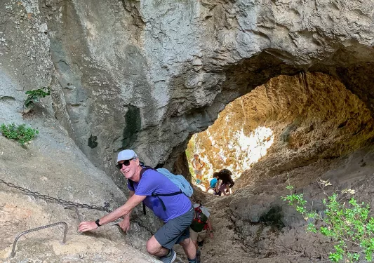 Backroad Guests Climbing Through Rock Formation
