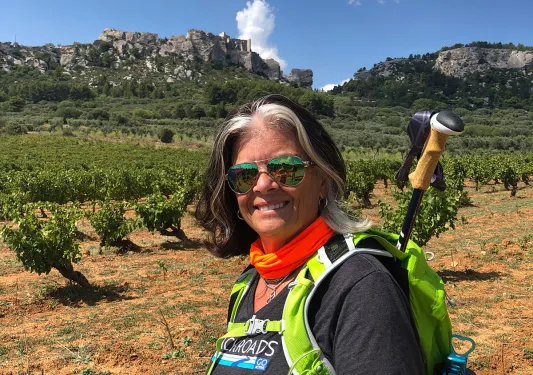 Backroads guest Smiling in Field with Rock Formation