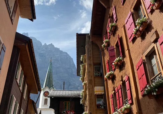 Point of view shot of Swiss alleyway, looking up towards moiuntains. 