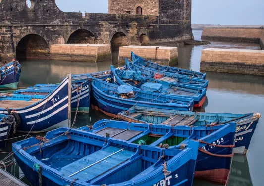 Port of Essaouira, blue scows docked in foreground