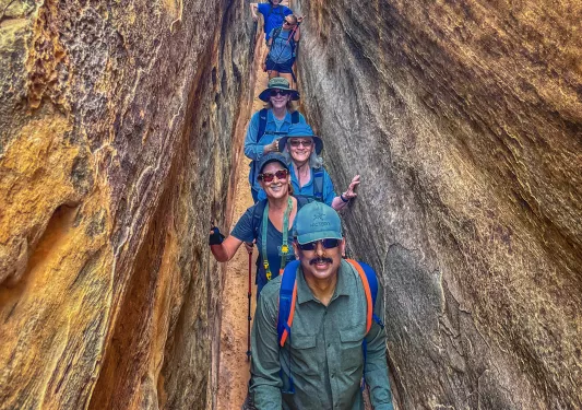 Guests lined up smiling in between rock walls