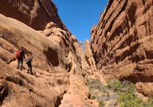 Hikers climbing boulders