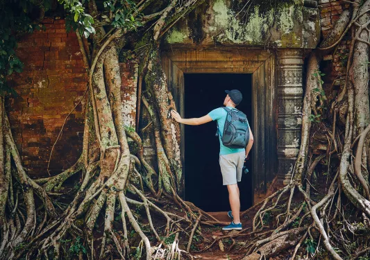 Person exploring the temple of Angkor Wat in Cambodia