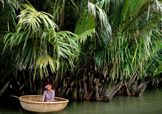 Riding down a jungle river in a round bottomed boat