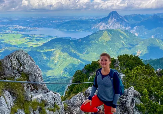 Hiker posing on a rock, clifside.