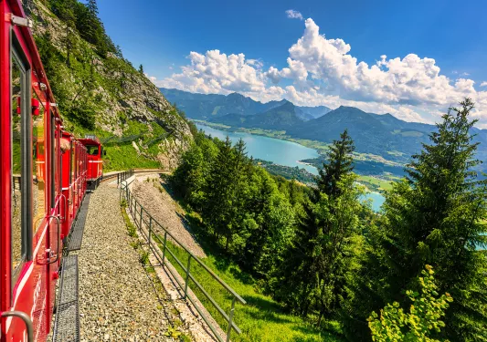 Alps with lush fields and green forests. View of lake Wolfgangsee.