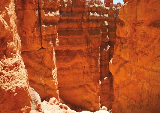 Hikers walking along rock formations