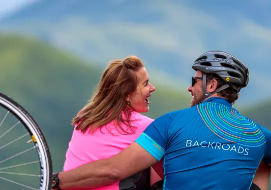 Backroads guests embracing one another after bike ride