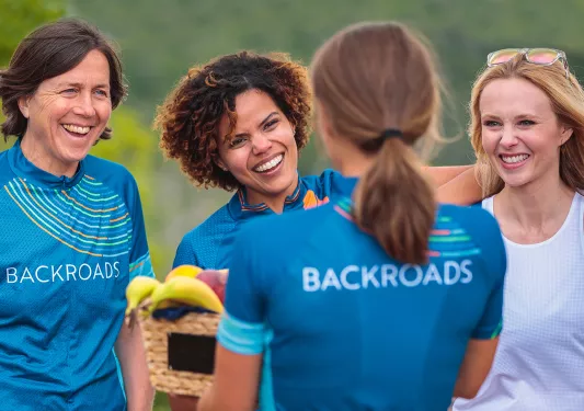 Four guests in BR gear, all smiling, talking.