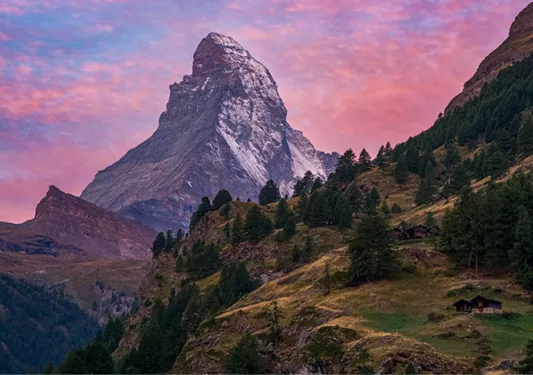 pink sunset behind a mountain