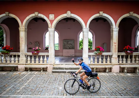 cyclist riding by columns